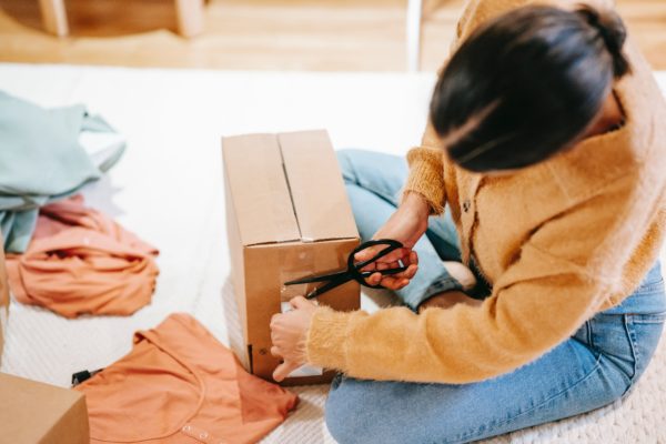 10 Ways to Enhance Your Small Business's Shipping and Packaging 1 woman small business packaging